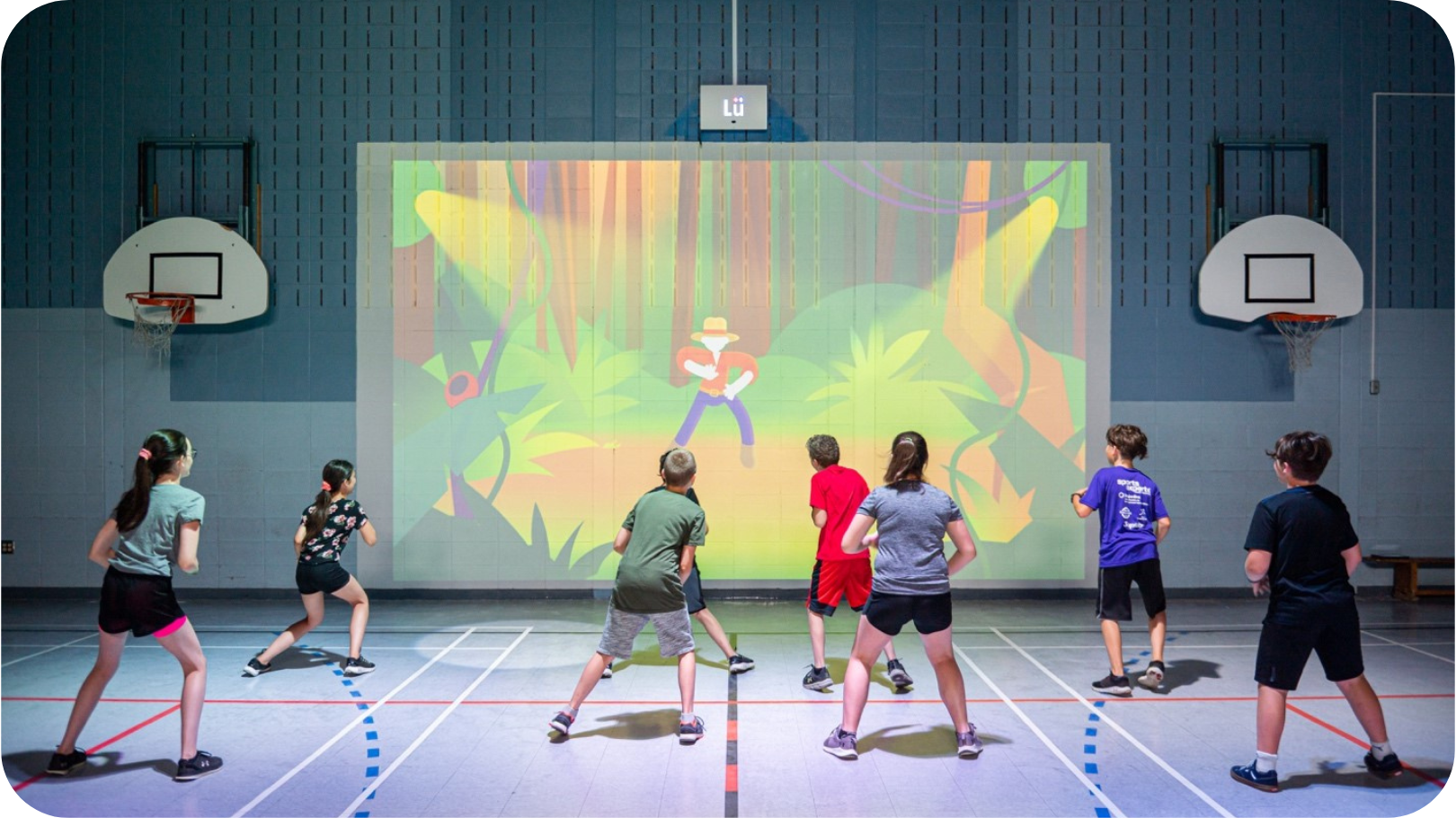 Children exercising in front of gym audio visual equipment for schools