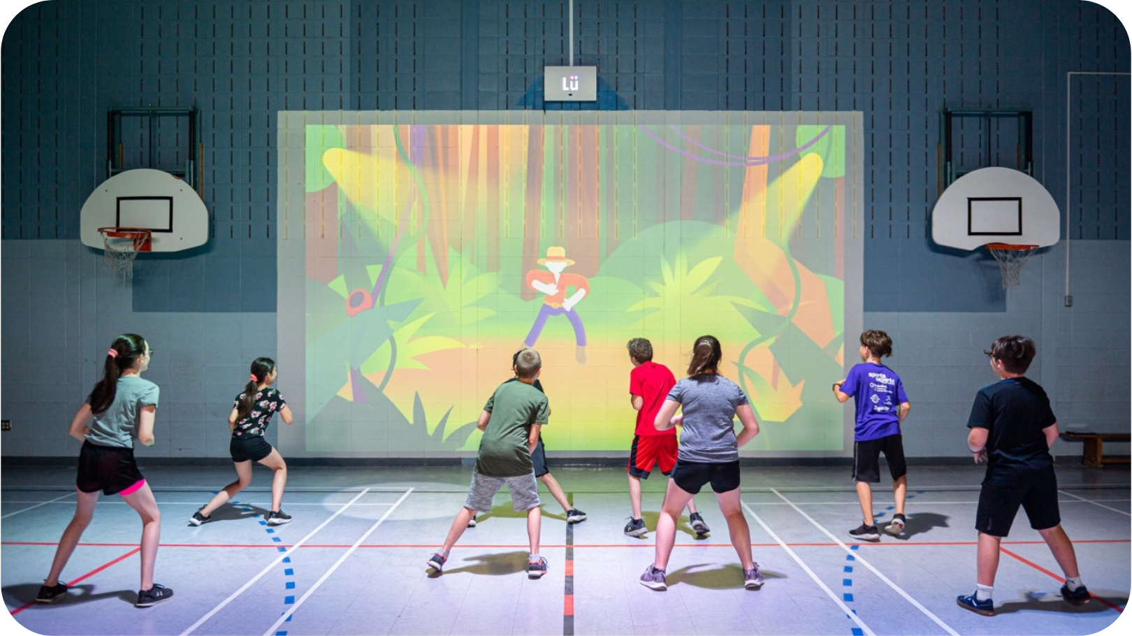Children exercising in front of gym audio visual equipment for schools